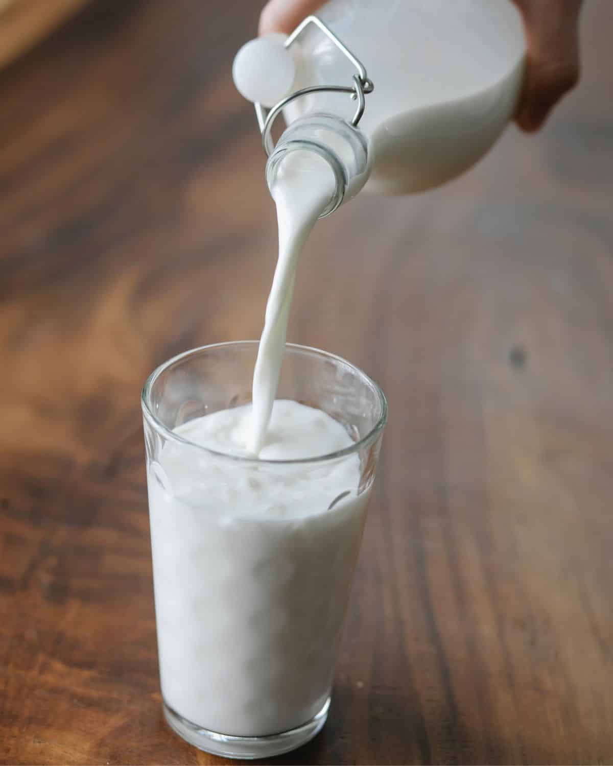 one big glass of milk with milk being poured into it - 1 of the 18 types of milk 