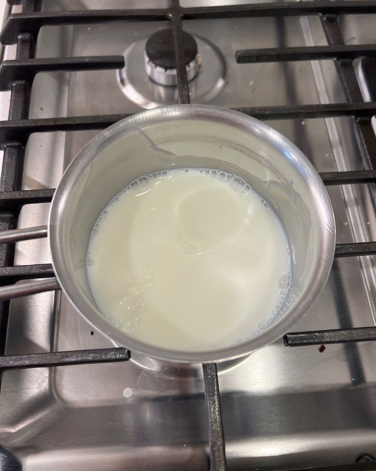 milk being warmed up on stove 