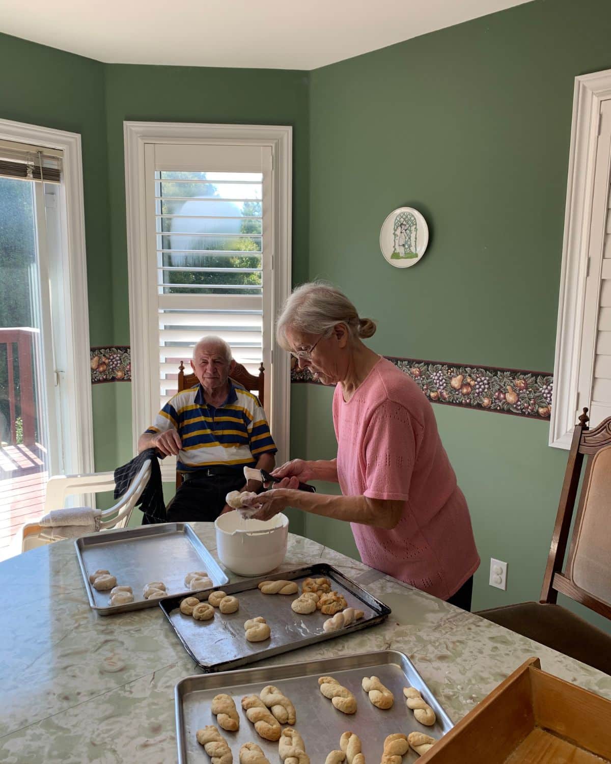 nonna and nonna in kitchen nonna icing cookies nonno watching 