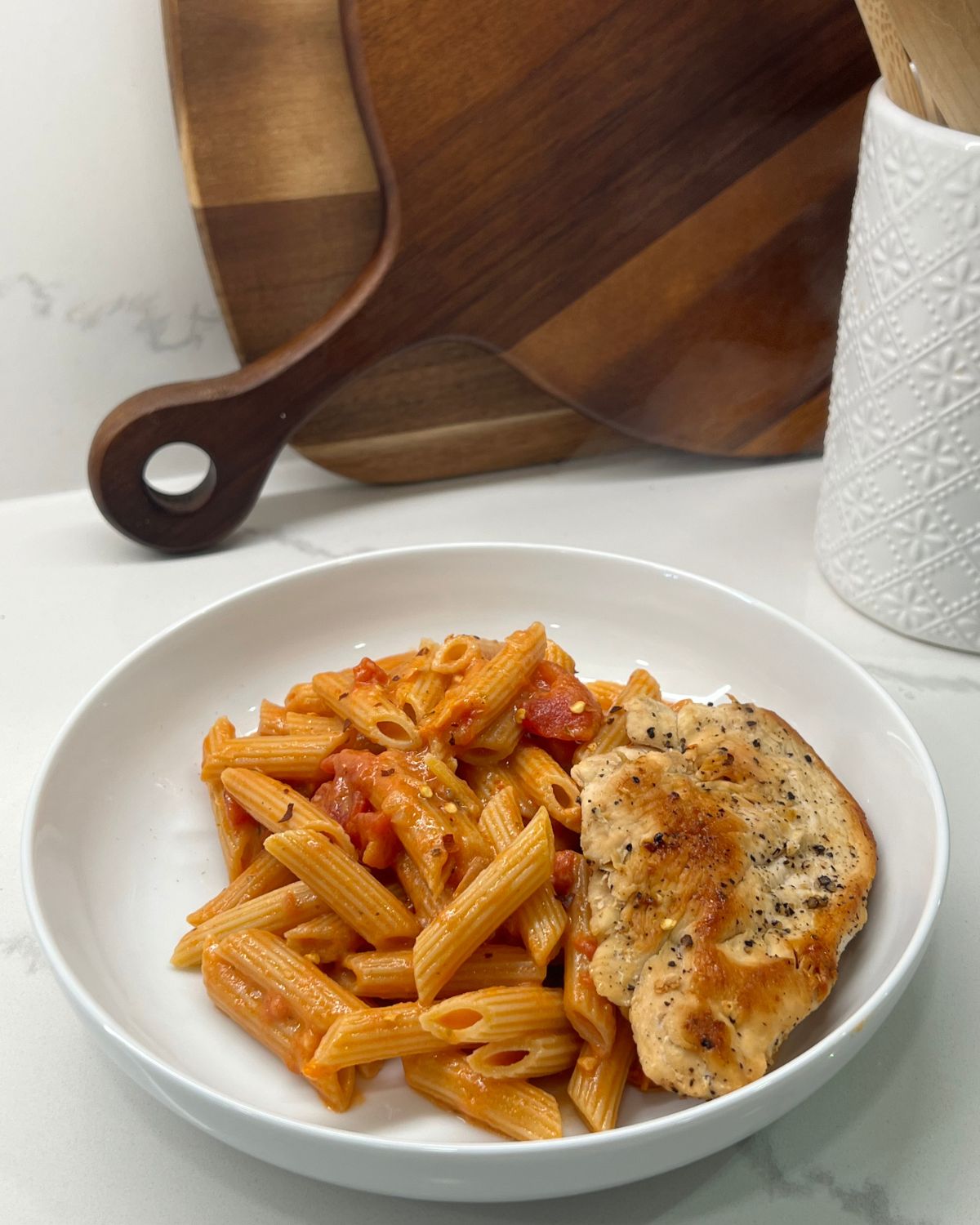 chicken and pasta with red sauce in bowl