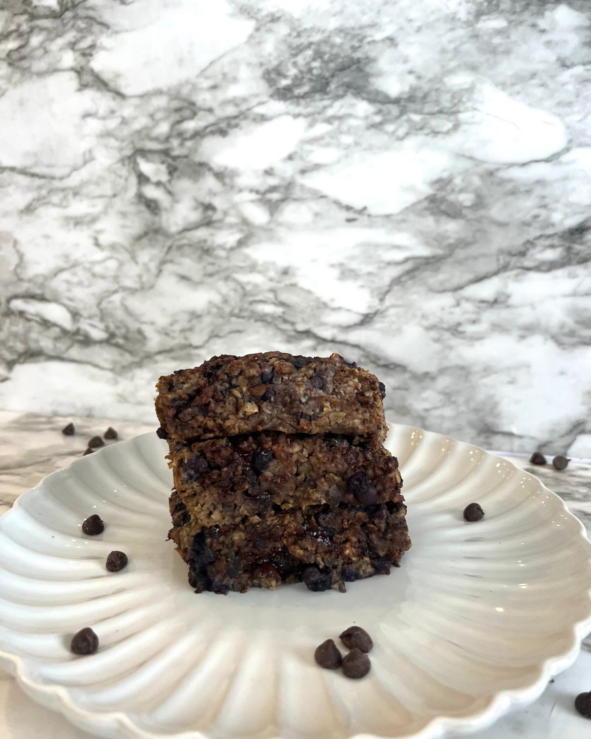 3 oatmeal chocolate chip bars stacked on top of each other 