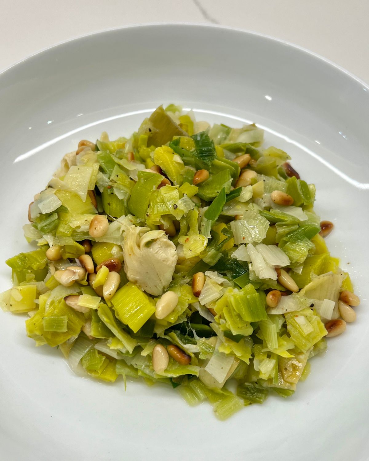 leek salad in a white bowl 