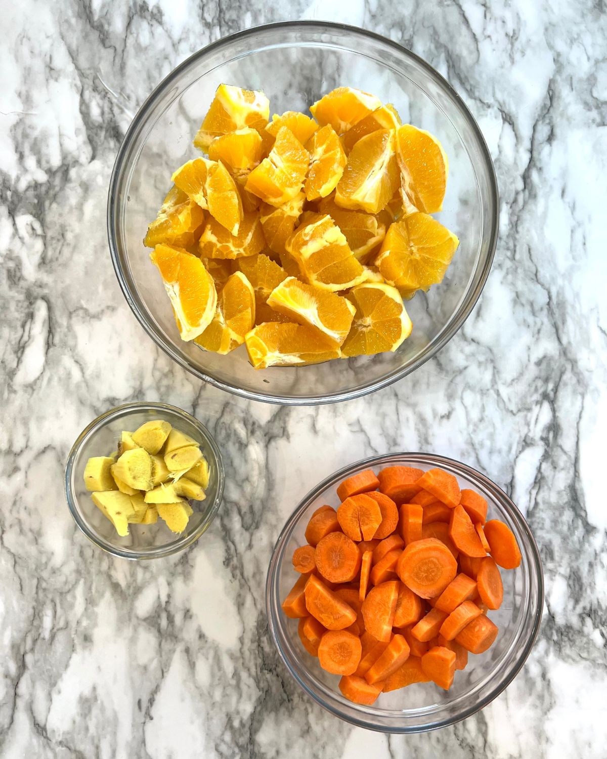 orange carrots and ginger laid out on table washed and chopped 