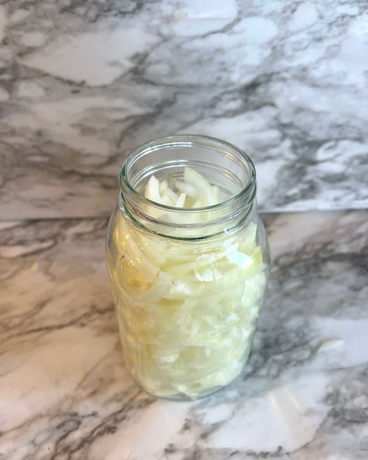 jar of white onions in mason jar 