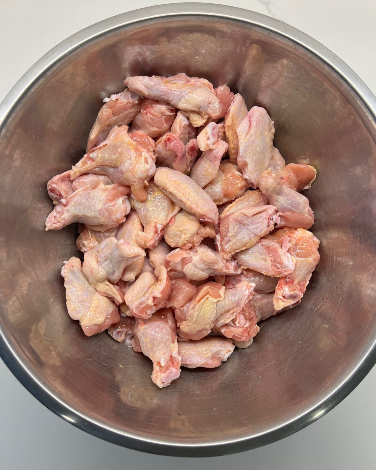 bowl of chicken wings no dry rub on them yet 