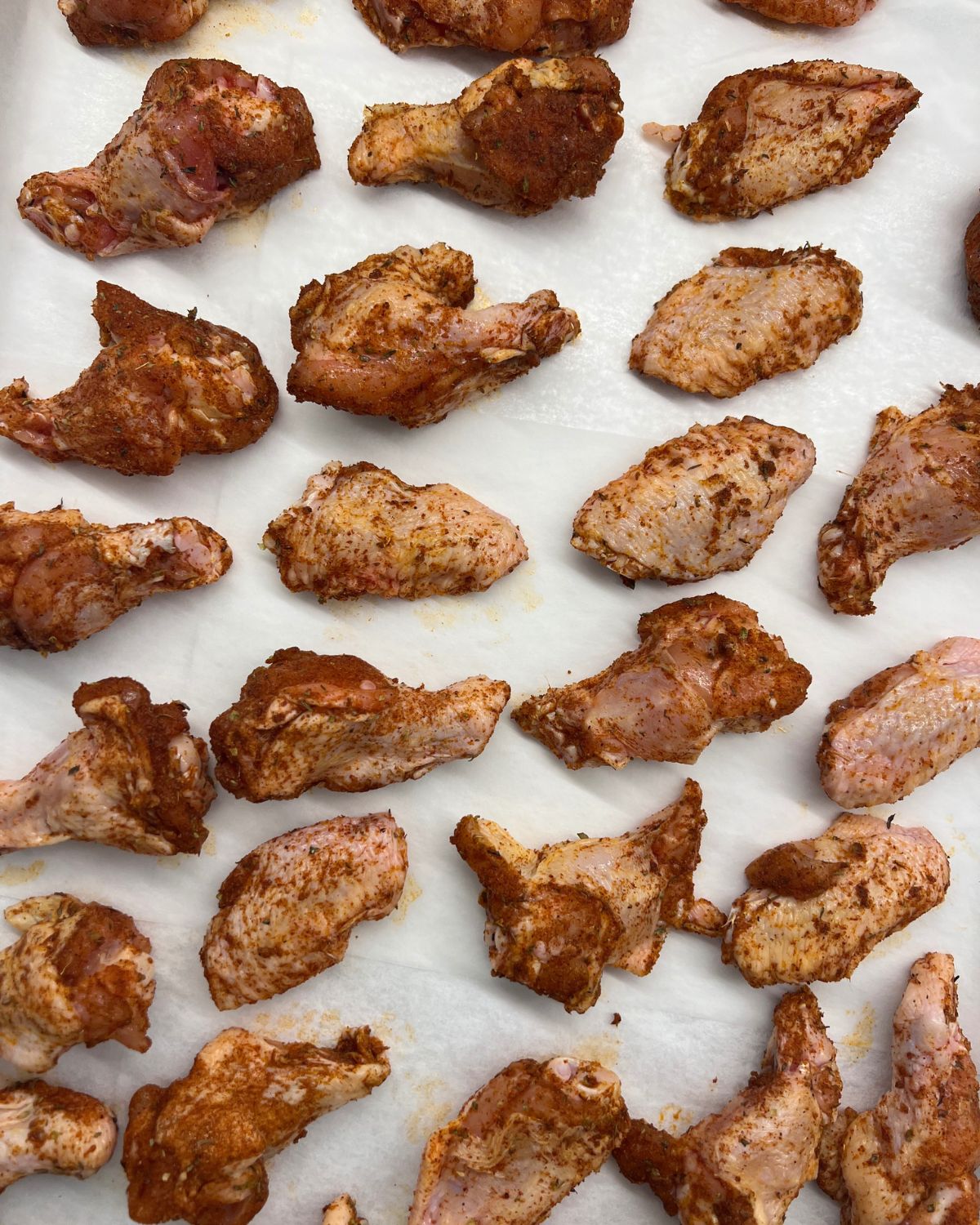 tray of chicken wings seasoned ready for oven 