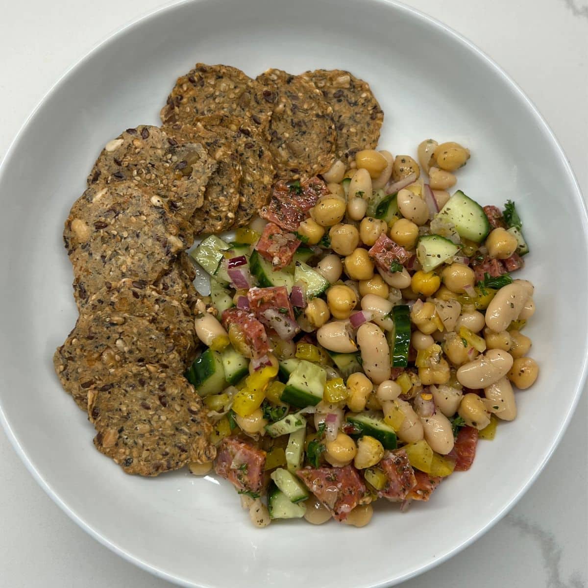 bean salad in bowl with crackers