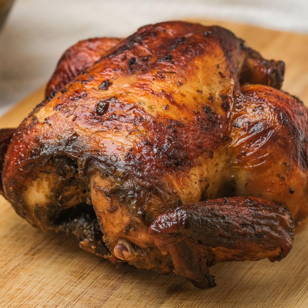 rotisserie chicken on a cutting board not cut