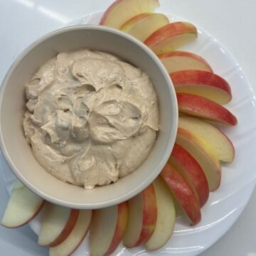 dip in a bowl with sliced apples beside