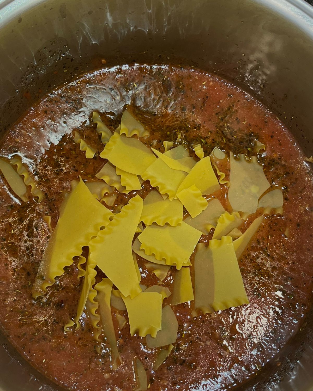 noodles added to the big pot of soup 