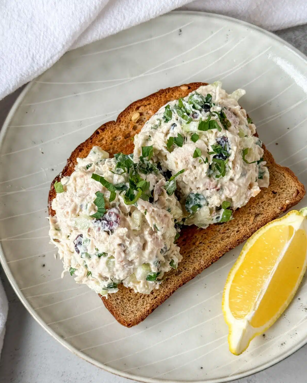 chicken salad two scoops on toast with lemon slice on it. 