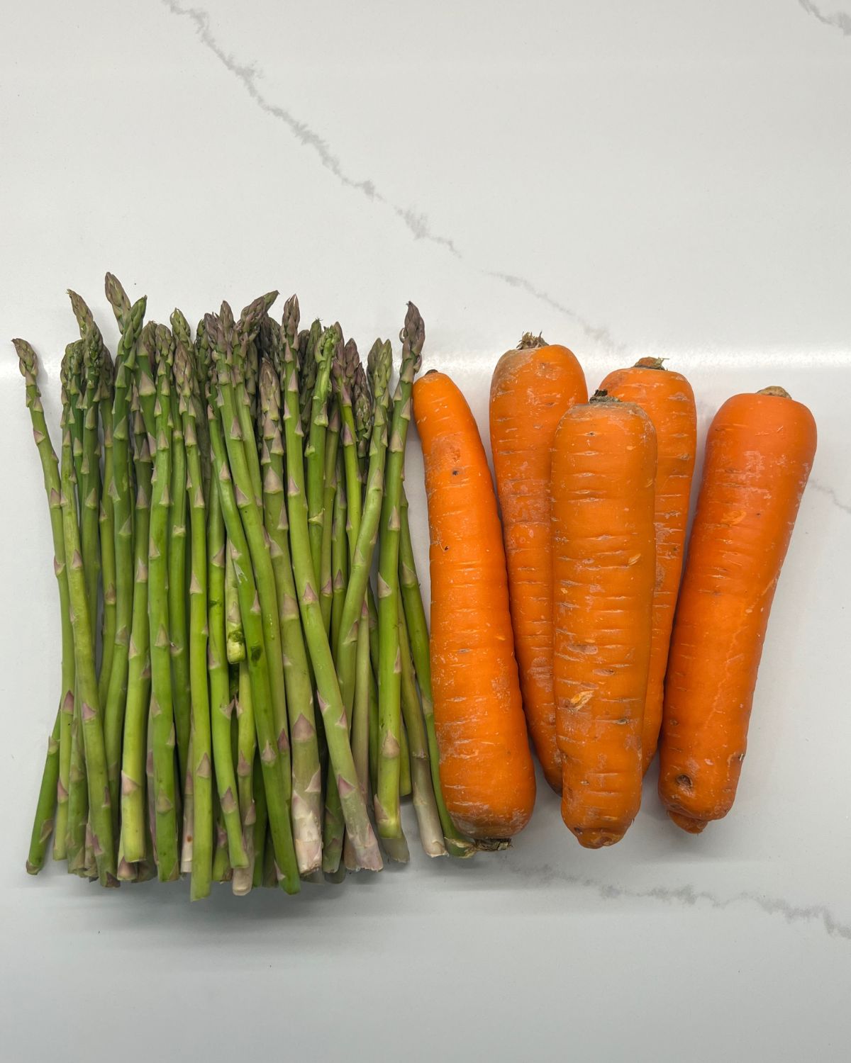 asparagus and carrots on counter  