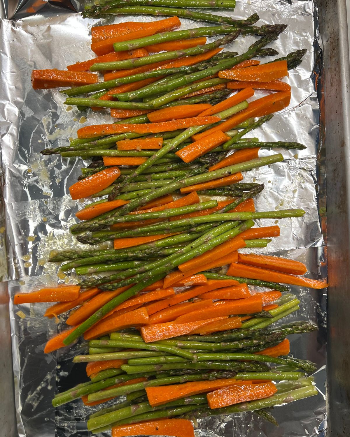 Roasted Asparagus and Carrots on baking tray ready to bake in oven 