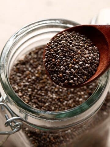 mason jar with chia seeds - wooden spoon scooping them out