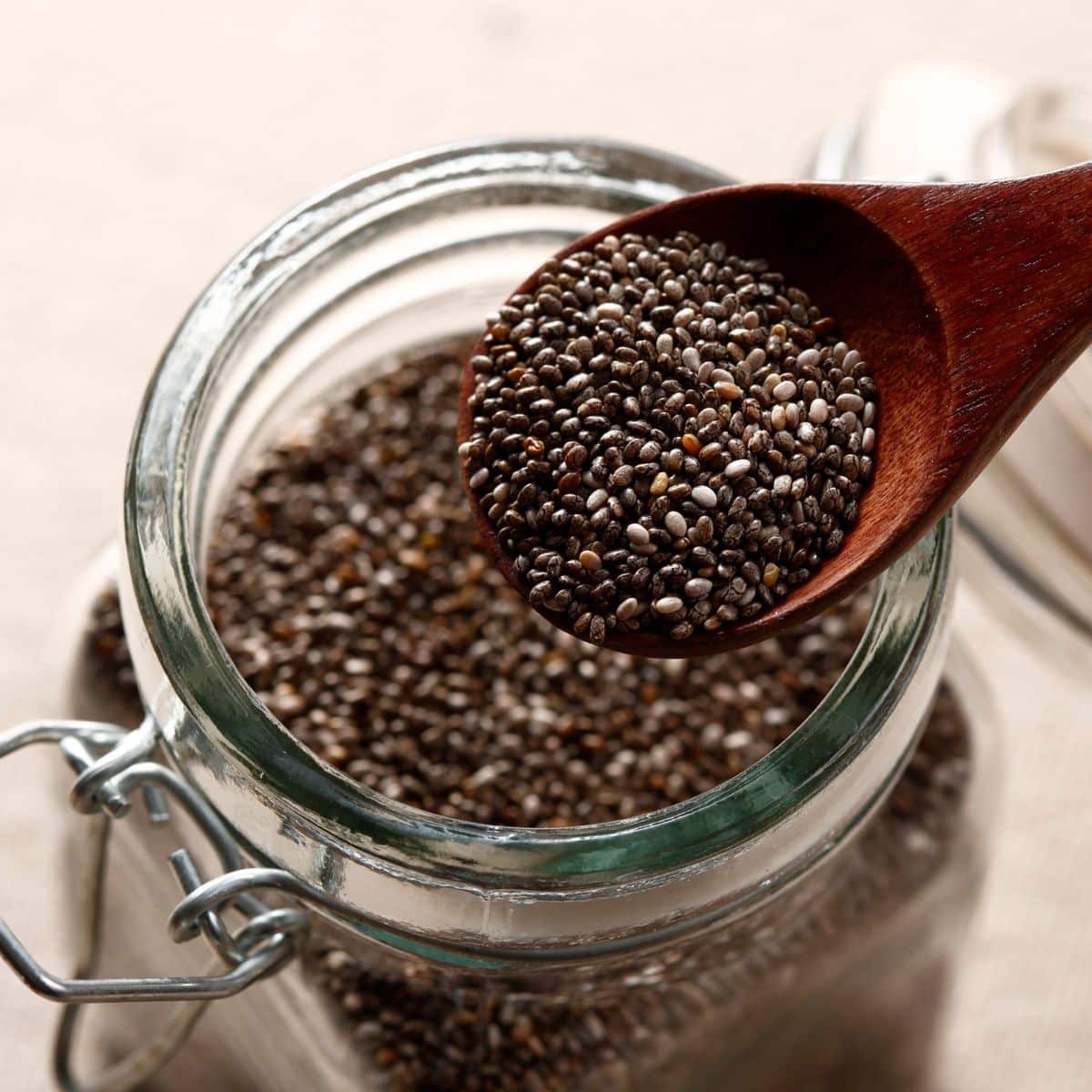 mason jar with chia seeds - wooden spoon scooping them out