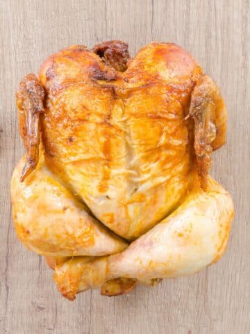 Rotisserie Chicken on counter top with a fork and knife beside