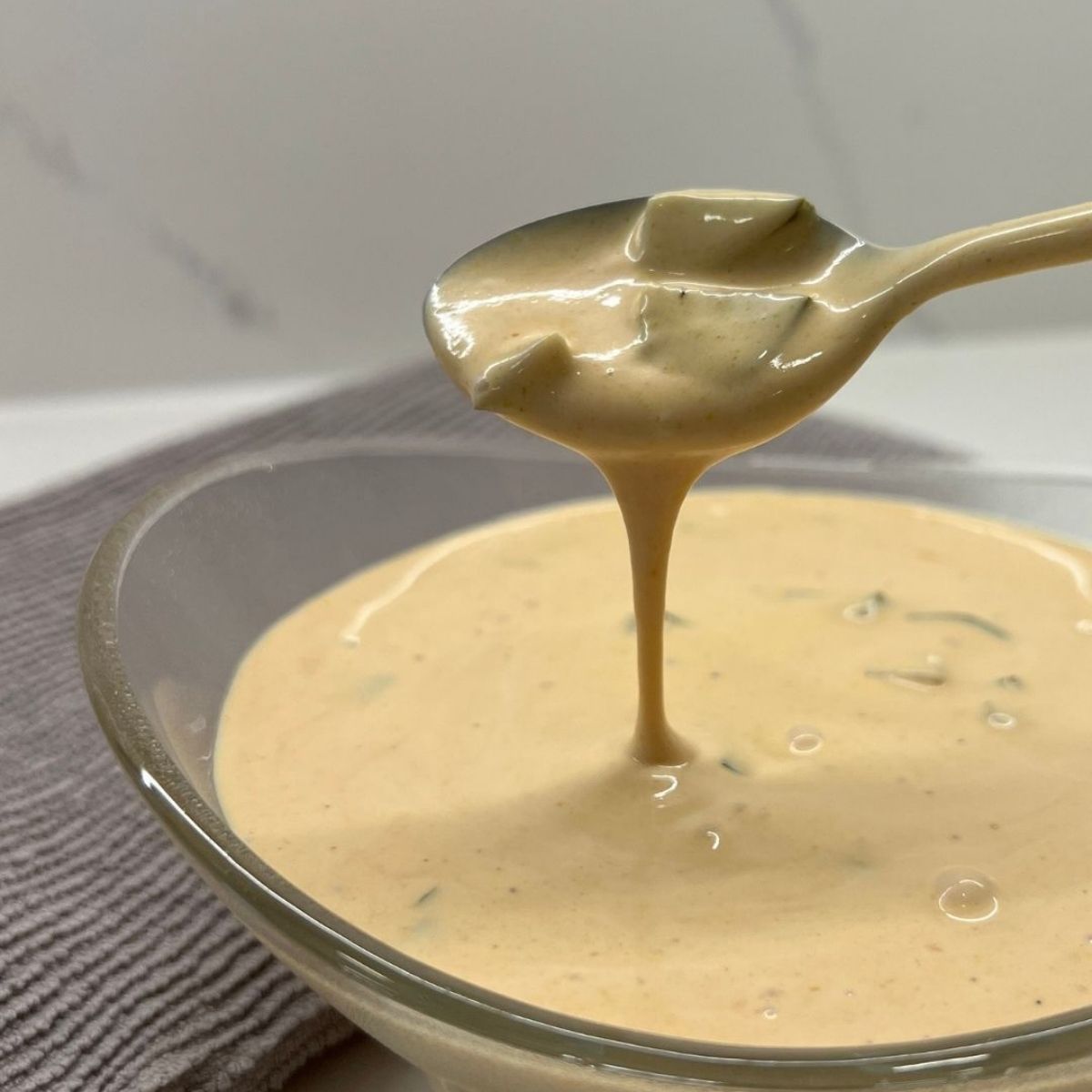 close up shot of the big mac sauce - scooping it out at camera