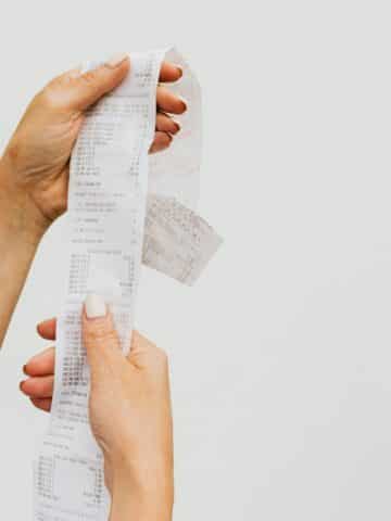 hands holding up a receipt