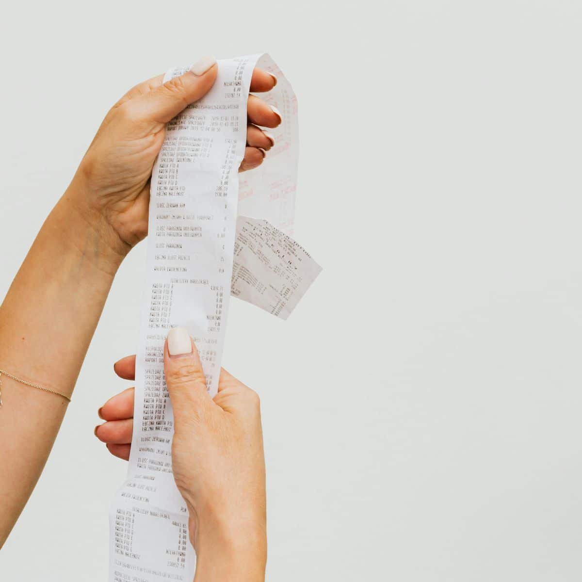 hands holding up a receipt