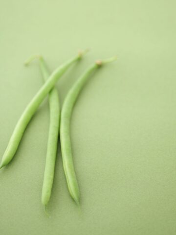 green background with 3 green beans