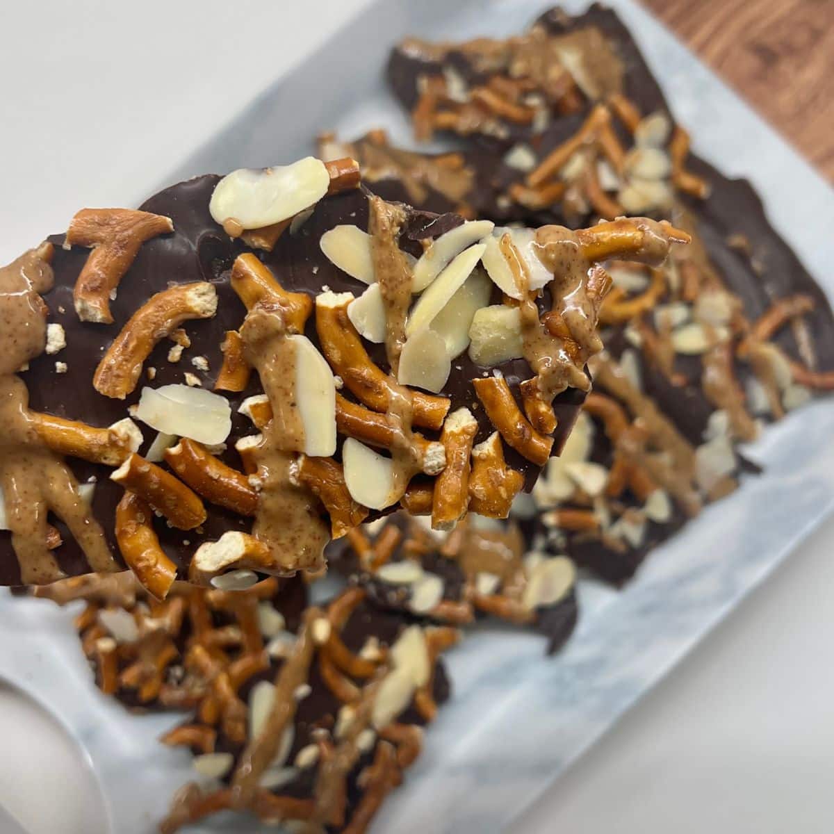 Pretzel Almond Bark close up shot holding up a piece to the camera